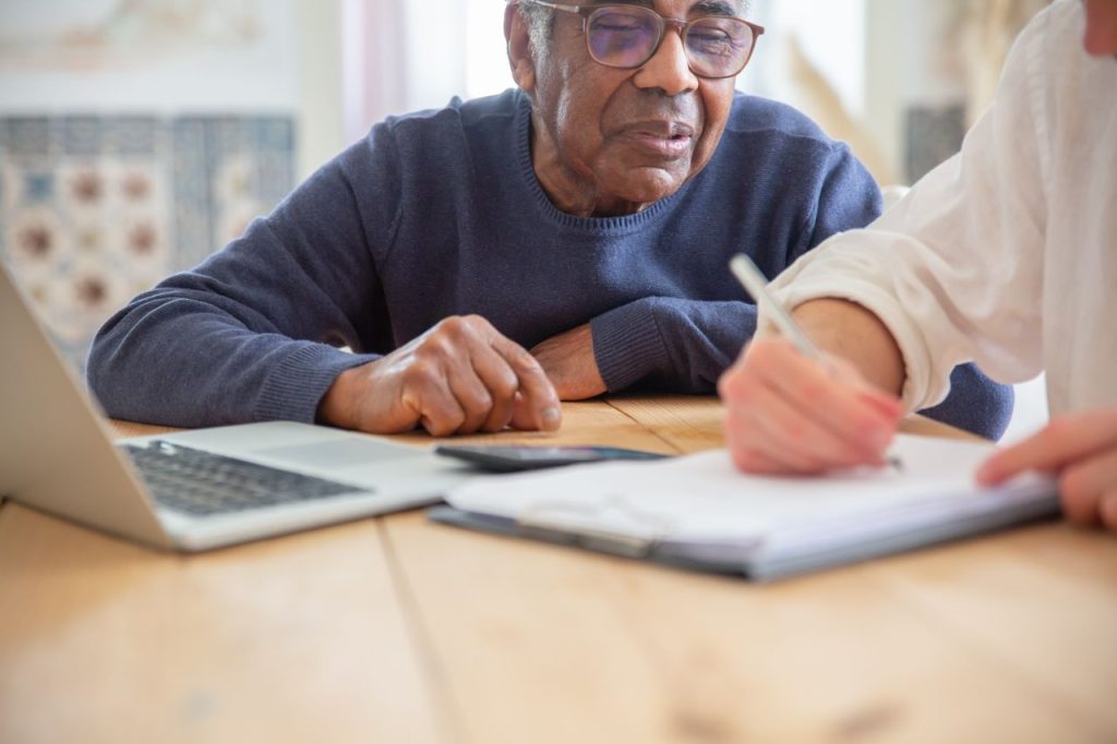 Family member reviewing a nursing home resident's care plan and medical records
